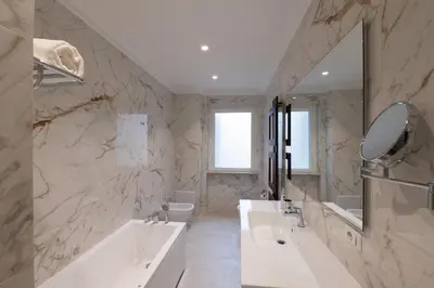 a bathroom with two sinks and a large mirror at La Scalinata - Boutique Guest House in Rome