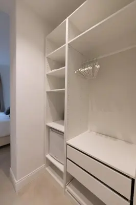 a white walk in closet with white shelves at La Scalinata - Boutique Guest House in Rome