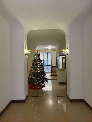 a christmas tree in the middle of a hallway at La Scalinata - Boutique Guest House in Rome