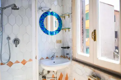 a bathroom with a sink and a mirror at Appartamento storico borgo Pio in Rome