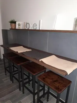 a table with stools and a table with papers on it at La Casetta Monteverde in Rome