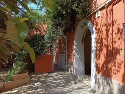 an alley with an entrance to a building with a door at Deco Garden Apartment Trastevere in Rome