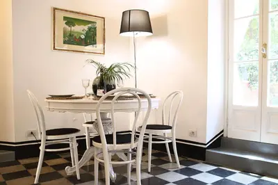 a dining room with a table and chairs at Deco Garden Apartment Trastevere in Rome