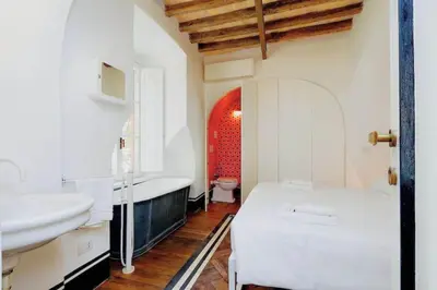 a bathroom with a sink and a tub and a toilet at Deco Garden Apartment Trastevere in Rome