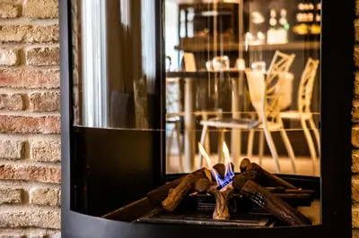 a fireplace with some logs on top of it at The Place 217 in Rome