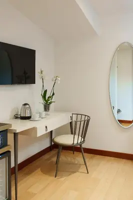 a desk with a chair and a mirror at The Place 217 in Rome