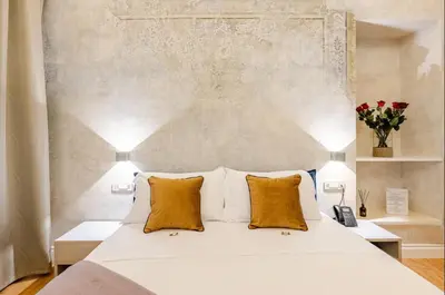 a bedroom with a white bed with orange pillows at The Place 217 in Rome