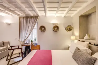 a bedroom with a bed and a couch and a table at The Spanish Suite Piazza di Spagna in Rome