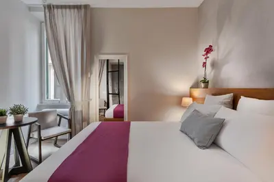 a bedroom with a large bed and a table at The Spanish Suite Piazza di Spagna in Rome