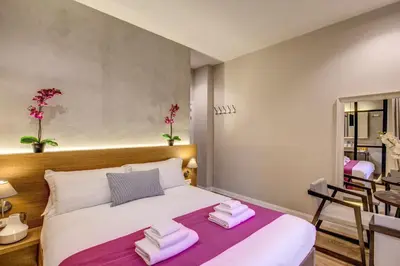 a bedroom with a bed with towels on it at The Spanish Suite Piazza di Spagna in Rome