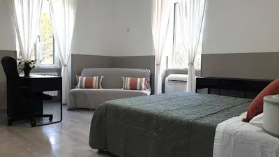 a bedroom with a bed and a desk and a chair at Giuseppe Apartment in Rome