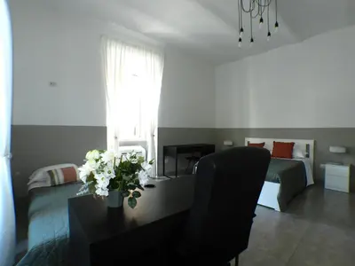 a living room with a table with flowers on it at Giuseppe Apartment in Rome
