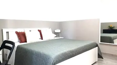 a bedroom with a bed and a mirror at Giuseppe Apartment in Rome