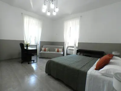 a bedroom with a bed and a desk and a chair at Giuseppe Apartment in Rome