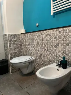 a bathroom with a toilet and a sink at Casa vacanze San Lorenzo in Rome