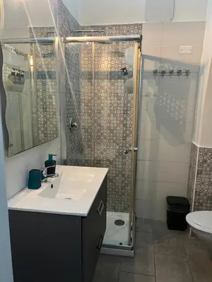 a bathroom with a sink and a shower at Casa vacanze San Lorenzo in Rome