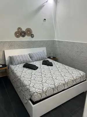 a bedroom with a bed with two black shoes on it at Casa vacanze San Lorenzo in Rome