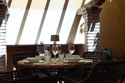 a table with chairs and wine glasses on it at Domus Duca Claudius I Classy Vatican Apartment With Private Garden in Rome