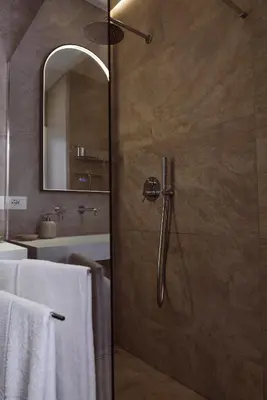 a shower with a glass door in a bathroom at Domus Duca Claudius I Classy Vatican Apartment With Private Garden in Rome