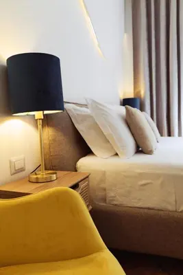 a hotel room with two beds and a lamp and a chair at Domus Duca Claudius I Classy Vatican Apartment With Private Garden in Rome