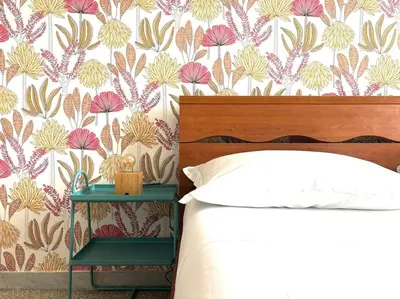 a bedroom with a bed and a floral wallpaper at Scalo Home in Rome