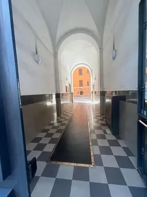a hallway of a building with a checkered floor at Scalo Home in Rome