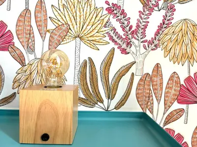 a glass trophy on top of a table in front of a floral wall at Scalo Home in Rome