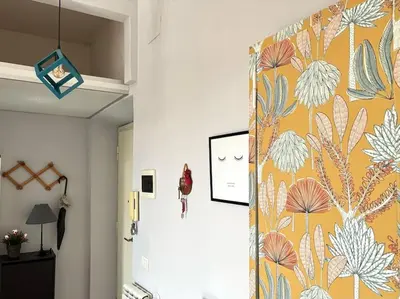 a hallway with a door with a floral wallpaper at Scalo Home in Rome