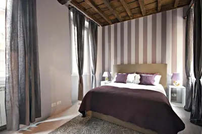 a bedroom with a large bed and a large window at Living Rhome-SpanishSteps in Rome