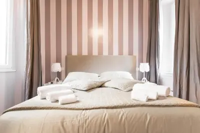 a bedroom with a bed with white towels on it at Living Rhome-SpanishSteps in Rome