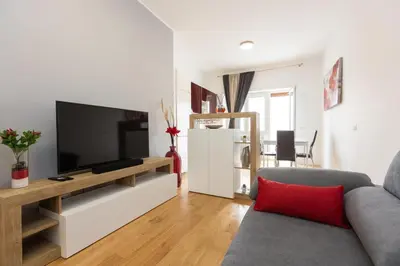 a living room with a couch and a television at Sweet Maya Home in Rome
