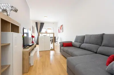 a living room with a couch and a television at Sweet Maya Home in Rome