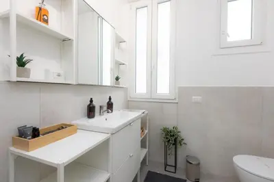 a white bathroom with a sink and a toilet at Sweet Maya Home in Rome
