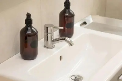 two bottles sitting on top of a bathroom sink at Sweet Maya Home in Rome