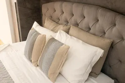 a bunch of pillows sitting on a bed at Sweet Maya Home in Rome