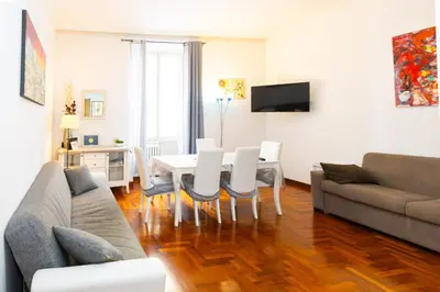 a living room with a couch and a table and chairs at Vespasiano 49 in Rome