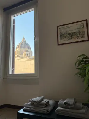 a room with a window with towels on a table at Maison Cavalleggeri in Rome