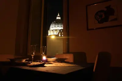 a table with a lit candle on a table with a capitol at Maison Cavalleggeri in Rome