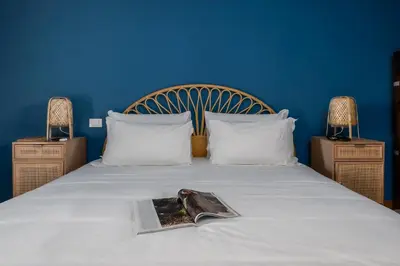a bedroom with a bed with a magazine on it at Da Giorgio e Teresa - Attico con terrazza a Piazza del Popolo in Rome