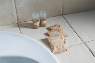 two bottles of honey sitting on the floor of a bathroom at Da Giorgio e Teresa - Attico con terrazza a Piazza del Popolo in Rome