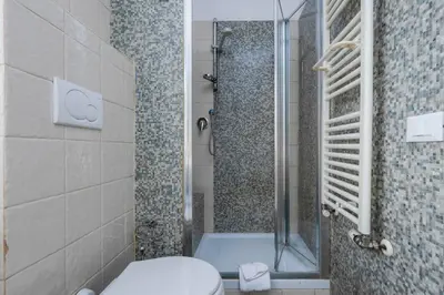 a bathroom with a shower and a toilet and a tub at Da Giorgio e Teresa - Attico con terrazza a Piazza del Popolo in Rome