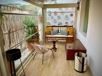 a balcony with a couch and a table and chairs at Da Giorgio e Teresa - Attico con terrazza a Piazza del Popolo in Rome