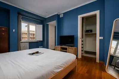 a blue bedroom with a bed and a television at Da Giorgio e Teresa - Attico con terrazza a Piazza del Popolo in Rome