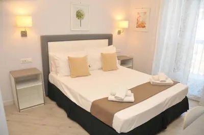 a bedroom with a large bed with two towels on it at MIGDAL Luxury Suites Roma Porta Portese in Rome