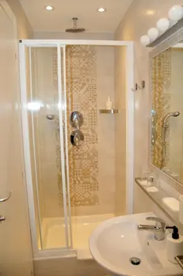 a bathroom with a shower and a sink at MIGDAL Luxury Suites Roma Porta Portese in Rome