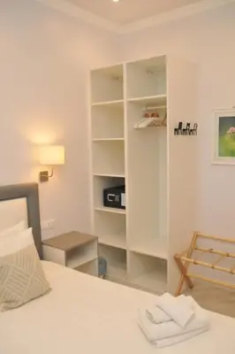 a bedroom with a bed and a book shelf at MIGDAL Luxury Suites Roma Porta Portese in Rome