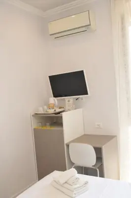a white desk with a computer monitor and a chair at MIGDAL Luxury Suites Roma Porta Portese in Rome