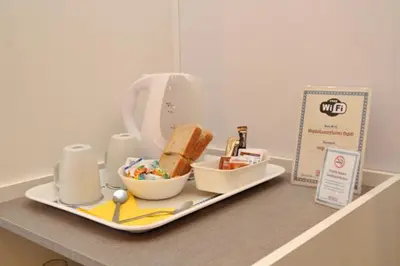 a tray with a plate of food on a counter at MIGDAL Luxury Suites Roma Porta Portese in Rome