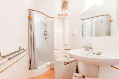 a white bathroom with a sink and a shower at 