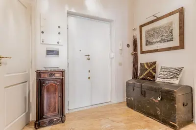 a room with a white door and a wooden chest at 